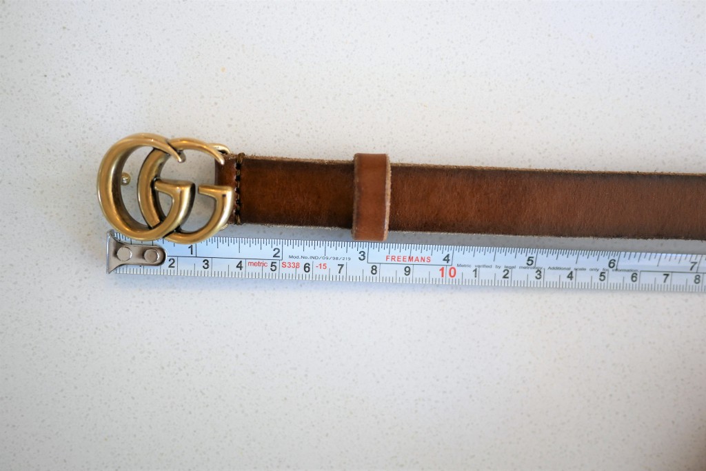 Measuring the length of the Gucci belt